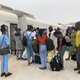 Travelers queue to board the train from the new train station in Ibadan to head to Lagos